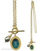 From our Mykonos Collection. Inspired by the beautiful waters off the Greek Island of Mykonos. !n Gold Plate, long necklace with transparent Zircon German glass intaglio pendant and Freshwater pearl charm. Pendant measures 1 by 3/4 inch. Necklace is 27 inhes in length. Each necklace made to order in the USA. 