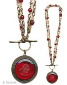 From our Scala Collection, our popular Convertible necklace in a transparent Cherry German glass intaglio. Large pendant measures 1 1/2 inches in diameter. Necklace of bronze, and semi-precious stones can be worn either as one  long strand at 34 inches, or short and doubled, at 17 inches. 