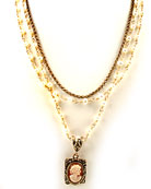 This hand-carved Italian shell cameo is set in a delicate rectangle. 3/4 inch pendant hangs from multiple strands of freshwater pearls and single strand of bronze. Very pretty look. Necklace measures 15 to 16 inches.