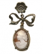 A traditional hand-carved Italian shell cameo drops from a Baroque bow and floral post. 