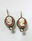 Hand-carved Italian shell cameo earring at 1/2 inch tall (10/8 mm). Delicate oval hand carved Italian shell cameo earring with faux pearl accent hangs from gold filled French hook. Shown in Bronze.