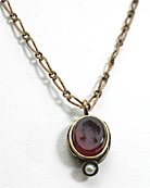10/8 mm oval pendant with single faux pearl accent dangles from a delicate fancy link chain 16"