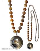 Our largest round intaglio featured in opaque Slate German glass on Botswana Agate hand knotted beads. Sporty with side toggle and mixed necklace. Pendant measures 1 1/2 inches in diameter. Necklace measures 33 inches in length. Shown in Silver Plate over bronze metal. Each necklace made to order in the USA from the world's finest materials.