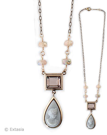 Delicate America necklace features rectangular crystal in Taupe and pear shaped cameo in Opaque Dove Gray German glass.  Chain is enhanced with hand faceted Rock Crystal beads with lovely AB finish.  Shown in bronze at 17 inches in length. Each necklace made to order in the USA from the worlds finest materials.