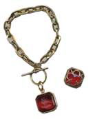 a single transparent Cherry German glass intaglio 3/4 inch square charm hangs from bronze chain. Handsome toggle closure. Very popular new bracelet. Dome back has beautiful gothic quatrefoil design as lovely as the front. Bronze metal. Fits all wrists, but can be made longer or shorter.