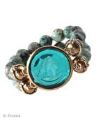 Double strand intaglio bracelet with African Turquoise beads shown in transparent Zircon German glass. Stretch bracelet fits most wrists. Center piece is 1 1/4 inches in diameter. Stunning colors! Bronze. Each bracelet made to order in the USA from the world's finest materials.