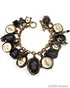 In classic black and white, multi-charm hand-pressed German glass intaglio charm bracelet. Largest charm is 1 1/4 by 1 inch. Bracelet length is 7 3/4 inches.