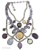 New for Fall, our Over The Top multi cameo/intaglio necklace. Stunning mix of neutrals and purples, the largest pendant measures 1 1/4 inches in diameter. Necklace measures 14 inches, interior strand to 18 inches, outer strand. Plus 3 inch adjustor to add length. Shown in our antique Silver Plate. Also available in our signature Bronze by request. Each necklace made to order in the USA, from the worlds finest materials.