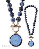 Toggle in front, 1 1/4 inch diameter pendant, on faceted hand knotted Sodalite beads.  18 inches in length. Shown here in our new transparent Saphhire German glass,  bronze metal. Each necklace made to order in the USA.
