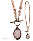 From our Scala Collection, a hand knotted transparent Taupe German glass intaglio necklace. Our designer could not resist the combination of Pink Moonstone beading with our best neutral color, the ever popular Taupe. Pendant is 1 1/2 inches long by 7/8 inch wide. 18 inches in length. Shown in our signature Bronze metal. Each necklace made to order in the USA from the worlds finest materials. 