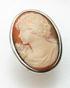 Large oval hand carved Italian shell cameo ring simply set has wide band shank. Sterling Silver setting. Cameo measures 1 1/4 by 1 inch. 