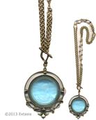 Large pendant necklace in a transparent Aqua German glass intaglio, can be worn two ways. Doubled, the necklace is 17 inches in length, and 34 inches when worn as a single strand. Freshwater pearl accents in necklace chain. Large pendant measures 1 3/4 by 2 inches. Bronze metal. Each necklace made to order in the USA.