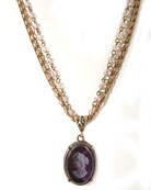 For the jewel-tone lovers, our very popular 3-strand intaglio necklace in transparent amethyst German glass. Pendant meaures 1 1/4 inch tall. Bronze. 17 inches in length.